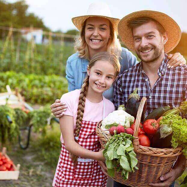 Satisfied farmers family with organic vegetables Satisfied farmers family with organic vegetables from garden